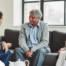 A caregiver talks with an elderly couple representing the kind of communication that professional caregivers need to have to anticipate client needs.