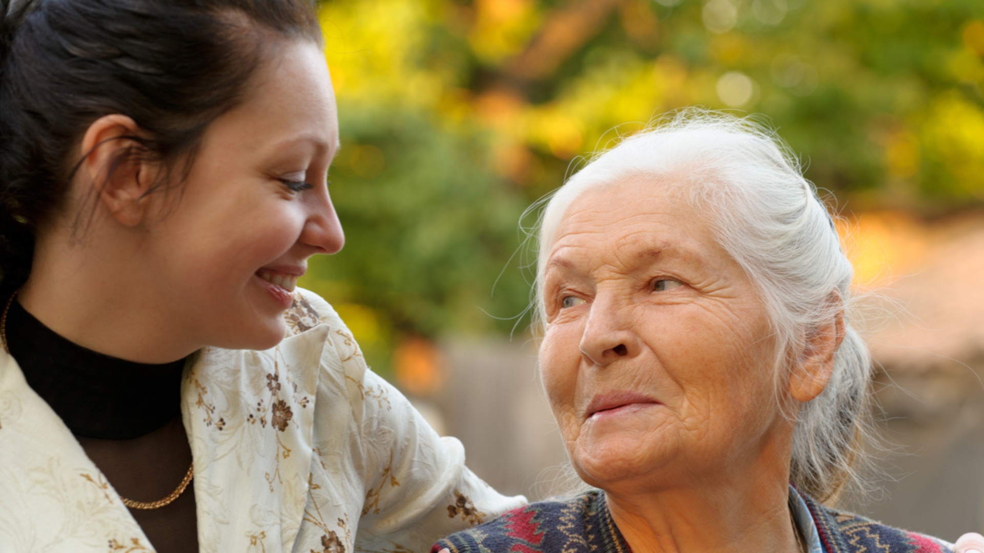 Senior Home Care in Altoona, A cheerful care giver outside with arm around elderly woman.