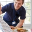 Professional caregiving involves helping clients with iADLs and ADLs as demonstrated by this caregiver helping a client by bringing a meal.
