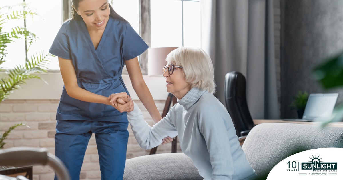 A caregiver demonstrates her caregiver skills by helping an older adult get up.