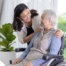A mother, her daughter, and her mother embrace, representing the sandwich generation.
