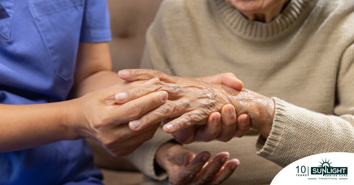 A care provider examines an older adult’s fingers, representing what would happen in an examination for rheumatoid arthritis.