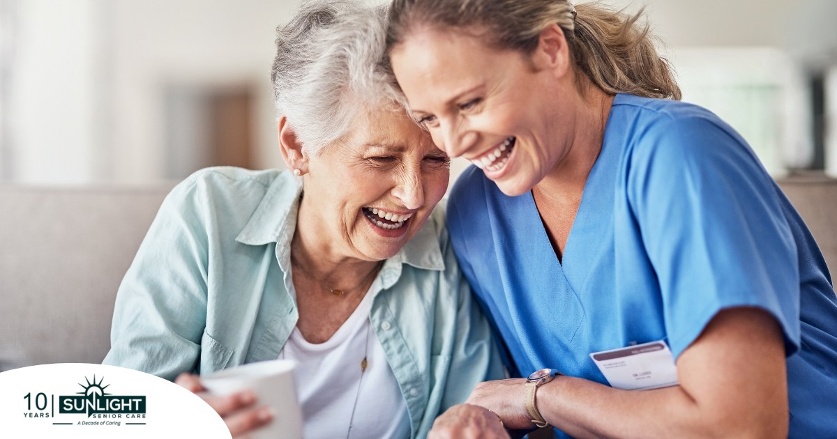 A woman in scrubs laughs with a senior woman, representing how caregiving can be a great career choice.
