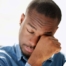 A man tiredly rubs his eyes, representing the exhaustion that can come with family caregiving.